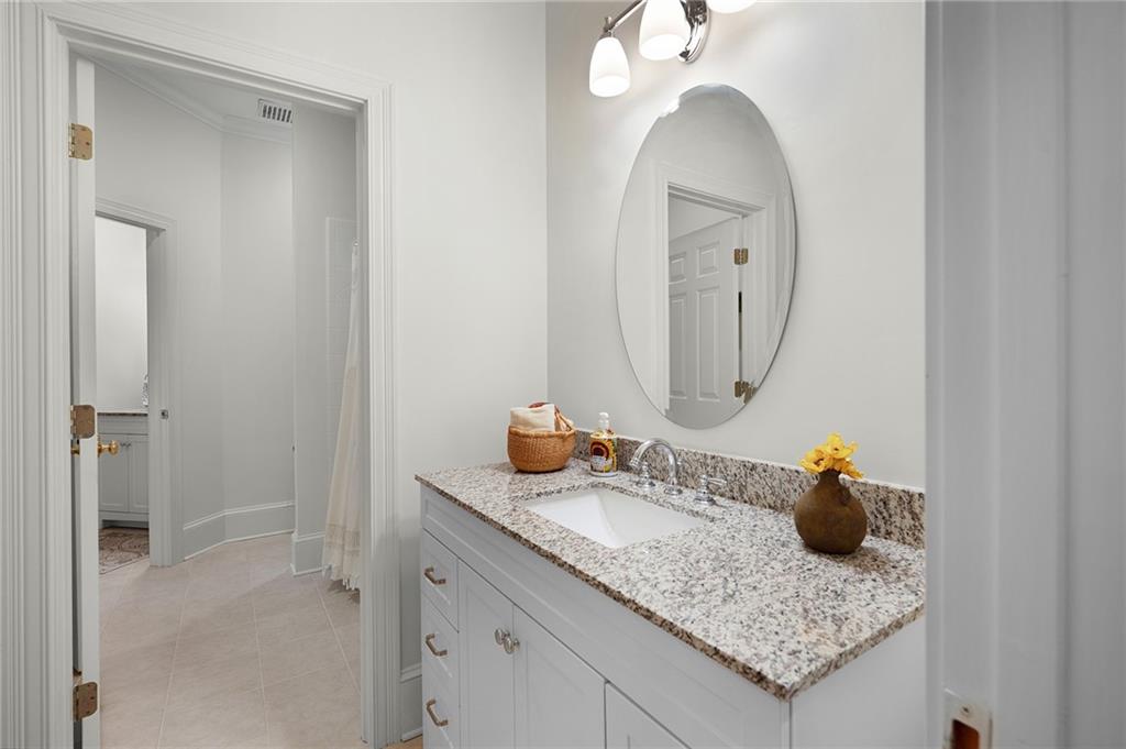 208 Muirfield Way Jasper, GA 30143 - Photo 45 of 59 a bathroom with a granite countertop sink and a mirror