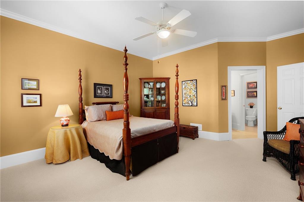208 Muirfield Way Jasper, GA 30143 - Photo 47 of 59 a bedroom with a bed and a chandelier