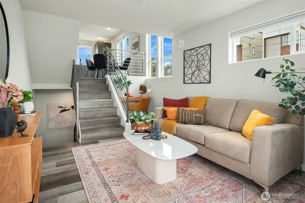 a living room with furniture and a potted plant