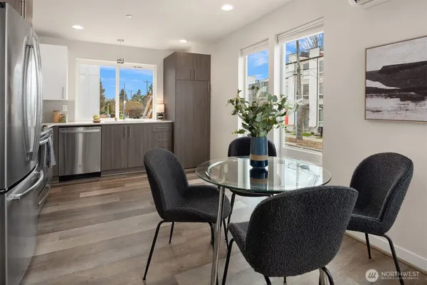 a view of a kitchen with stainless steel appliances granite countertop a refrigerator and a sink