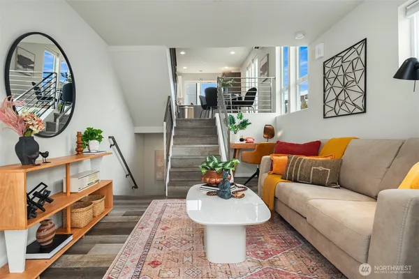 a living room with furniture and potted plant