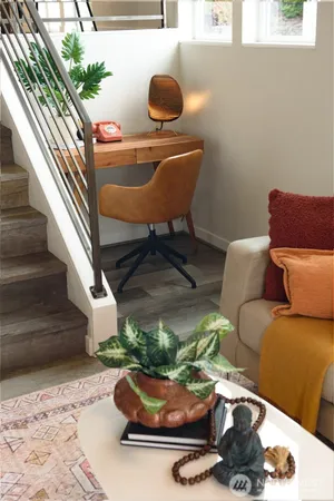 a living room with furniture and a potted plant