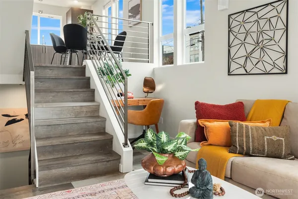 a living room with furniture and a potted plant