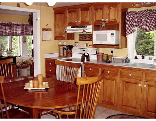 10 Wedgewood Road Sturbridge, MA 01566 - Photo 8 of 14 a kitchen with stainless steel appliances a sink a stove a dining table and chairs