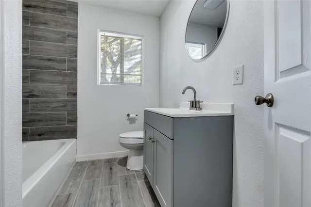 a bathroom with a sink a toilet and bathtub
