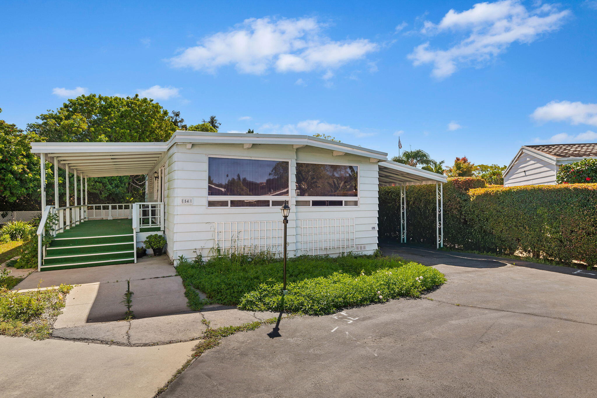 333 Old Mill Road, Unit 54 Santa Barbara, CA 93110 - Photo 4 of 13 a front view of a house with a garden and trees