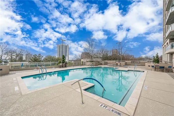 a large kitchen with kitchen island a sink stainless steel appliances and cabinets