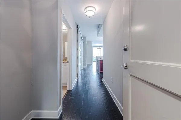 a view of a hallway with wooden floor