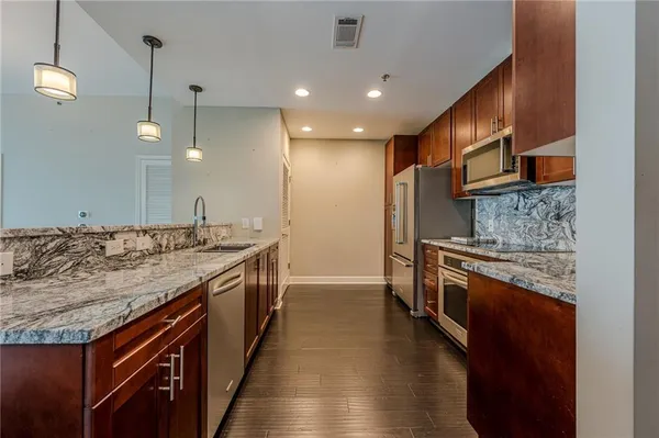 a bathroom with a sink a vanity and a large mirror