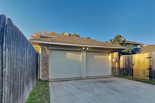 a white building with a white fence