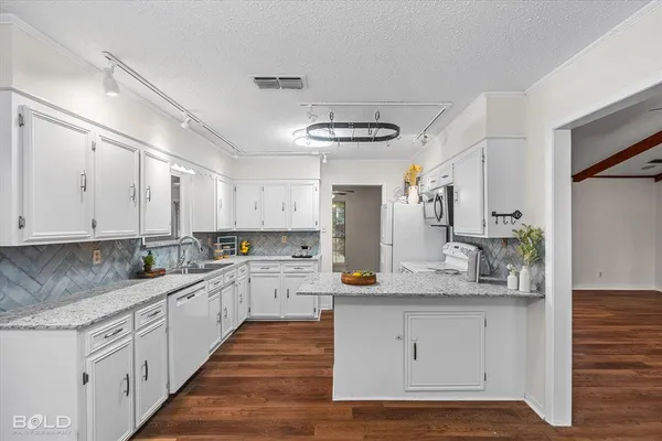 a view of a kitchen with wooden floor and a ceiling fan