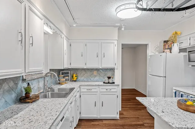 a kitchen with cabinets wooden floor and a fireplace