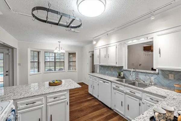 a kitchen with a refrigerator and a sink