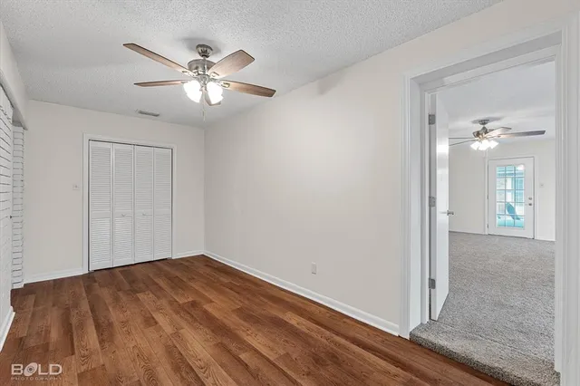 a view of an empty room with a ceiling fan