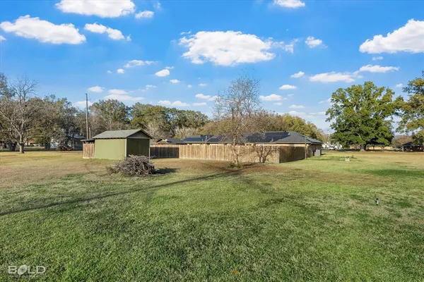 a view of a house with a yard and a garden