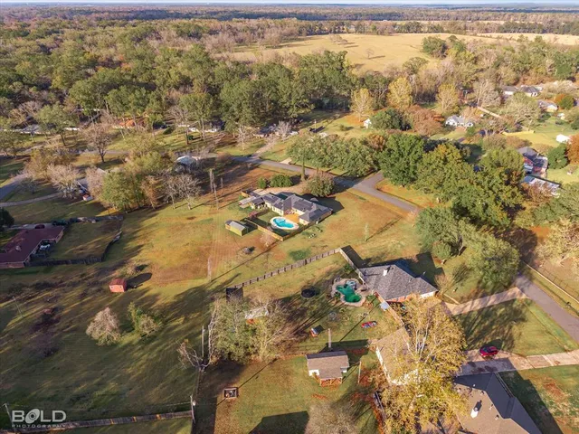 a view of a house with a backyard and pool