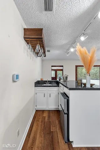 a kitchen with stainless steel appliances granite countertop a sink and wooden cabinets
