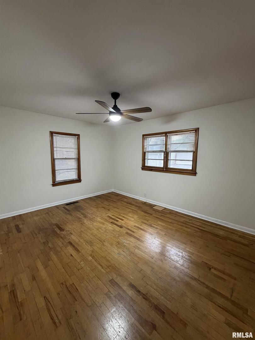 1806 Market Street Metropolis, IL 62960 - Photo 13 of 18 a view of a big room with wooden floor and windows