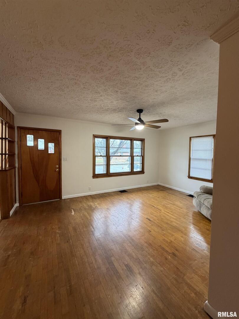 1806 Market Street Metropolis, IL 62960 - Photo 18 of 18 a view of an empty room with window and wooden floor