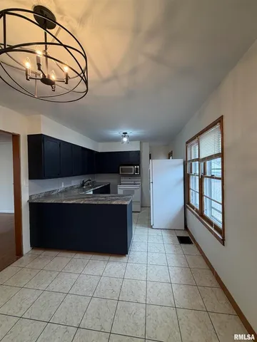 a view of kitchen with furniture and refrigerator