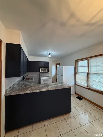 a kitchen with stainless steel appliances granite countertop a sink and a granite counter tops