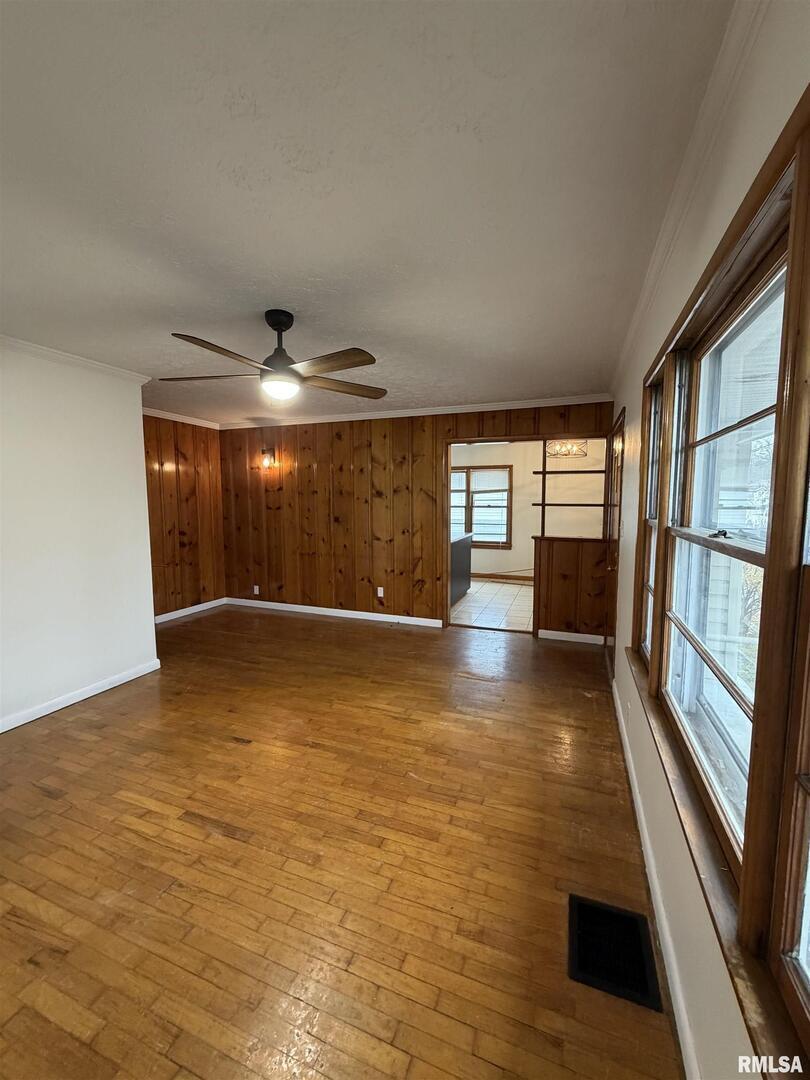 1806 Market Street Metropolis, IL 62960 - Photo 9 of 18 a view of empty room with wooden floor and fan