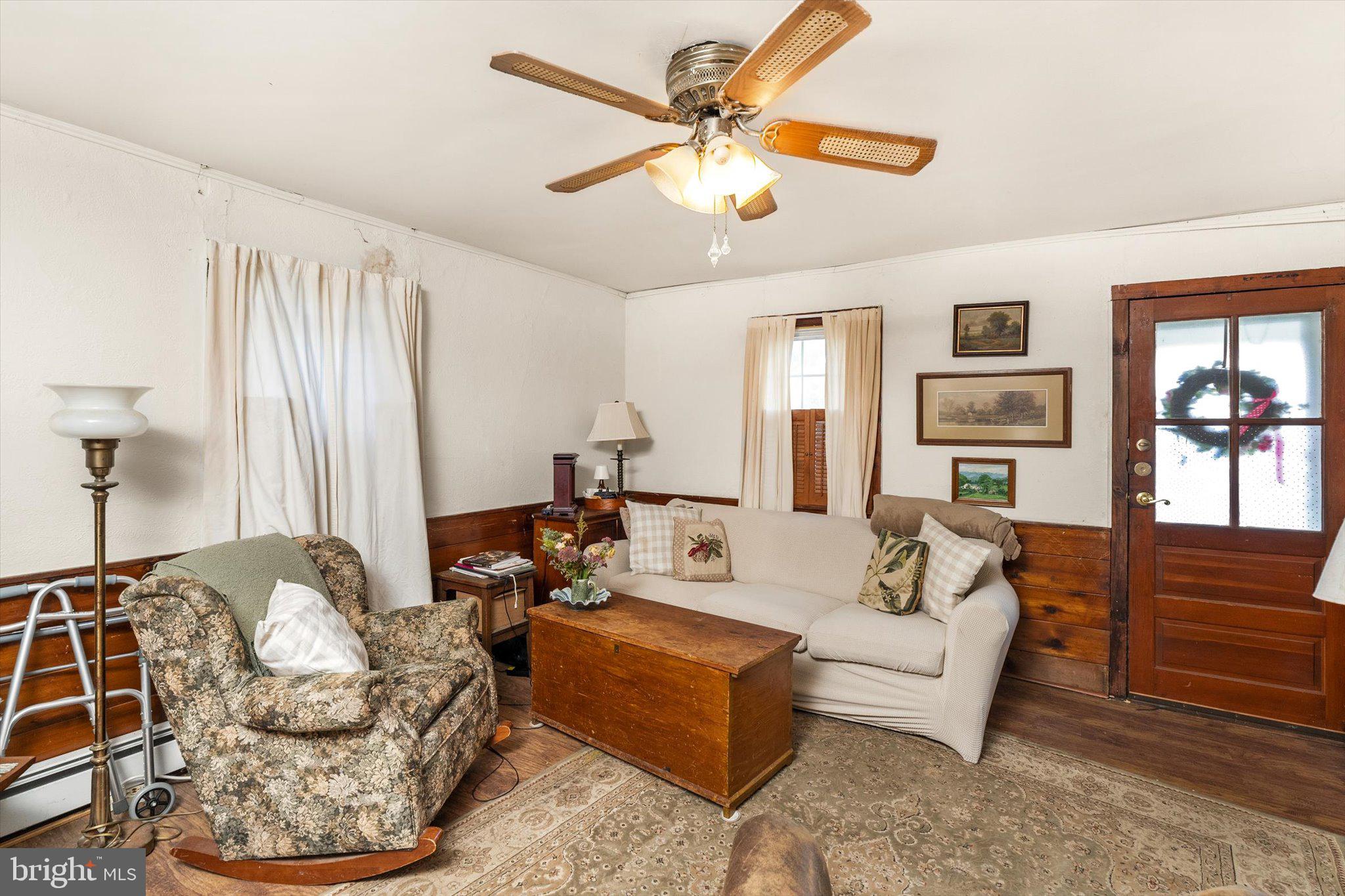 537 Arneytown-chesterfield Road Chesterfield, NJ 08515 - Photo 62 of 87 a living room with furniture a ceiling fan and a rug