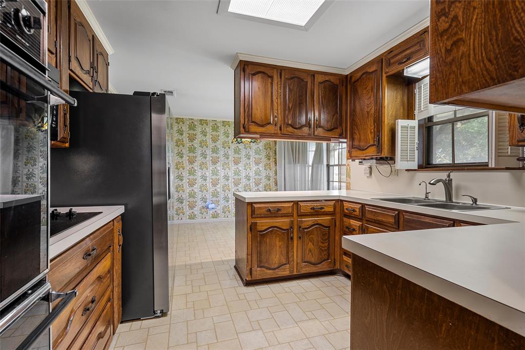 219 Opal Street Hewitt, TX 76643 - Photo 10 of 28 a kitchen with stainless steel appliances granite countertop a sink stove and refrigerator