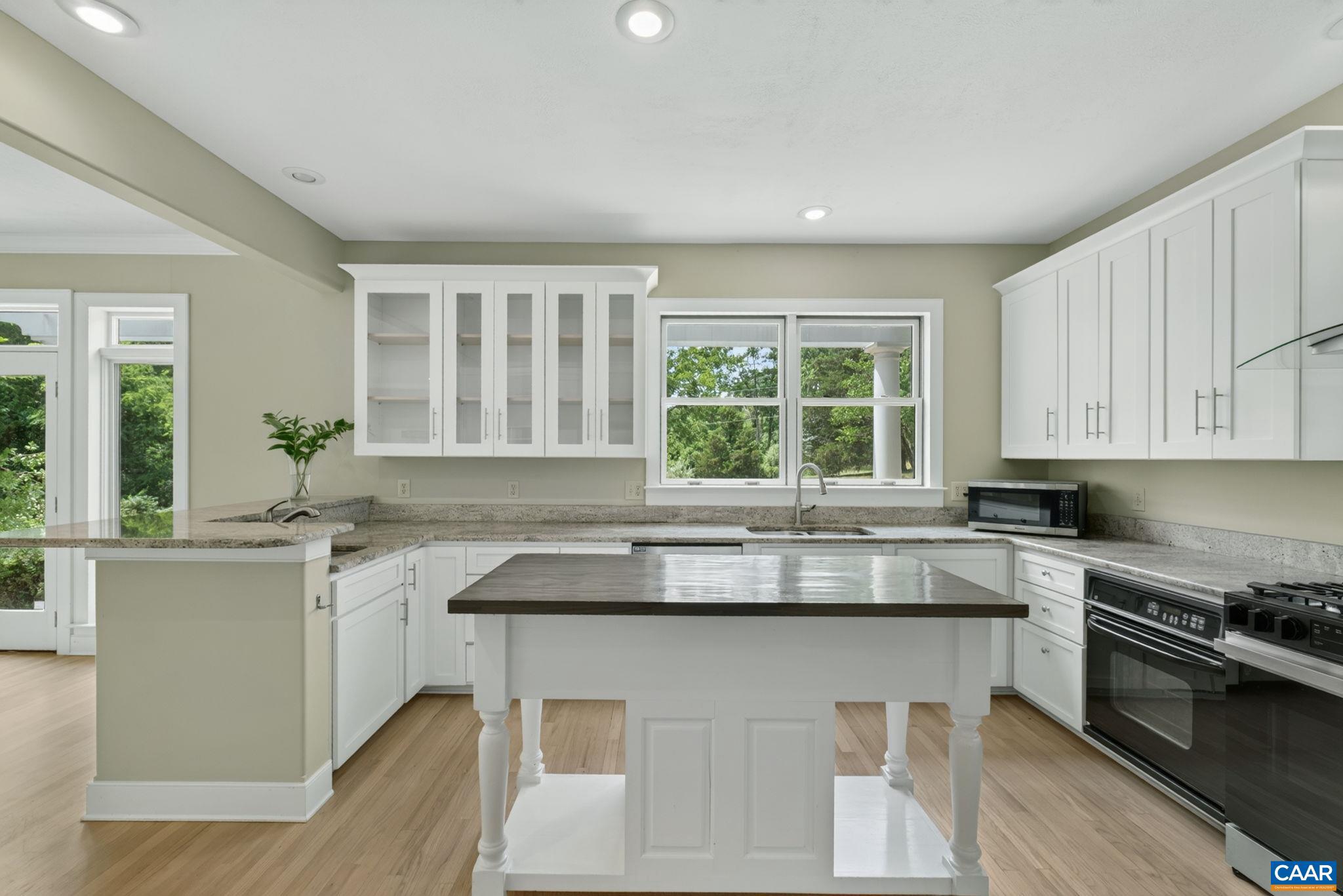 6285 Jarmans Gap Road Crozet, VA 22932 - Photo 3 of 65 a kitchen with stainless steel appliances granite countertop a stove a sink and a white cabinets