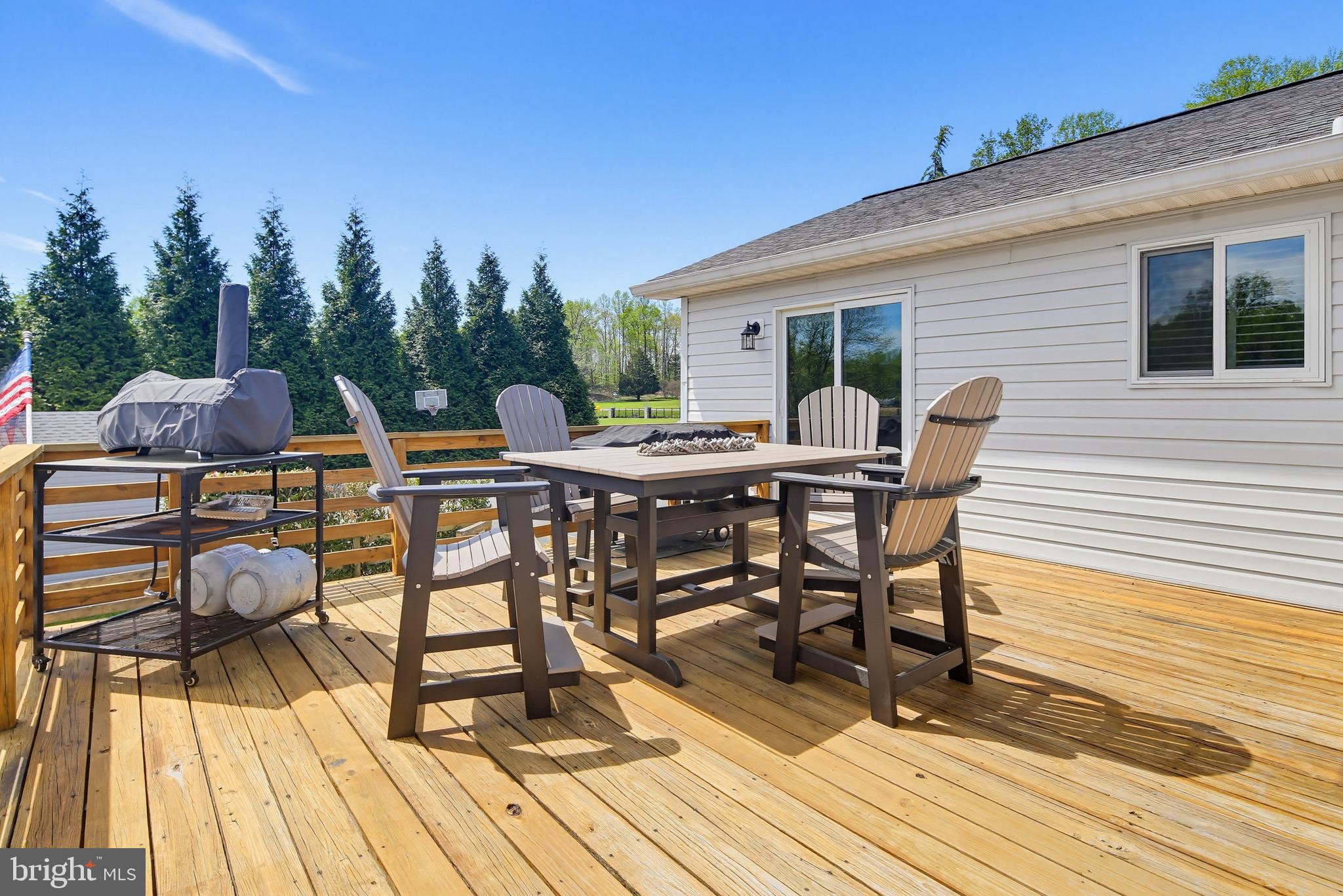 3229 Beards Point Road Davidsonville, MD 21035 - Photo 35 of 69 a view of a roof deck with table and chairs a barbeque with wooden floor and fence