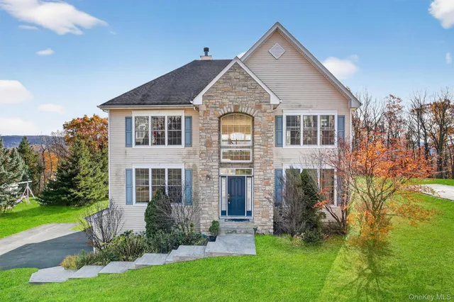 a front view of a house with a yard and porch