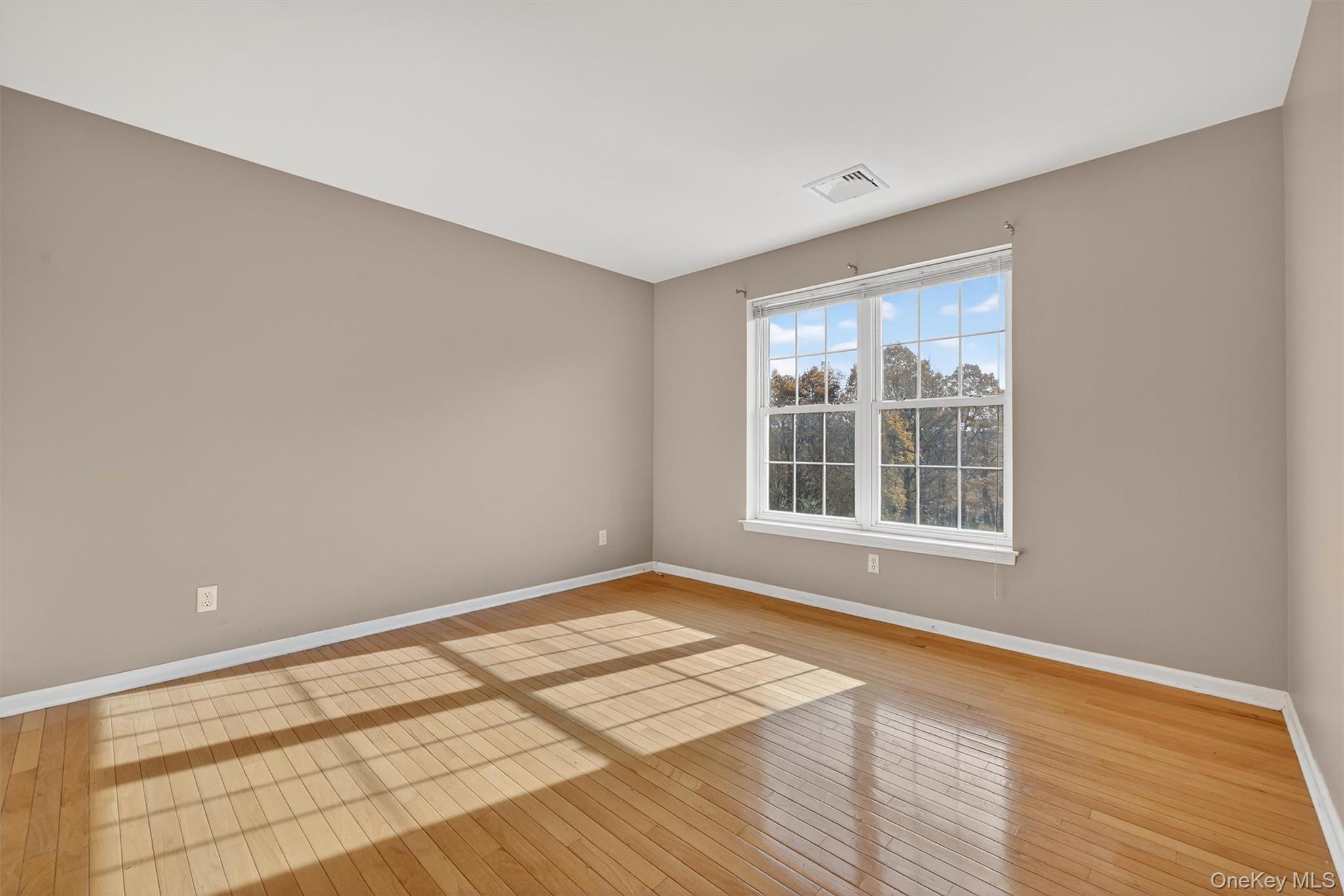 12 Heather Ridge Highland Mills, NY 10930 - Photo 22 of 41 a view of an empty room with wooden floor and a window