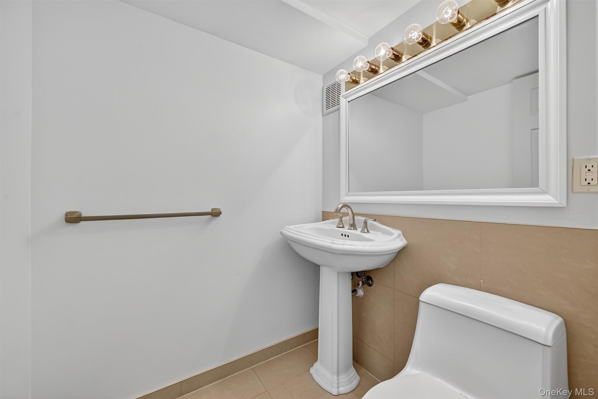 12 Heather Ridge Highland Mills, NY 10930 - Photo 28 of 41 a bathroom with a sink a toilet and mirror