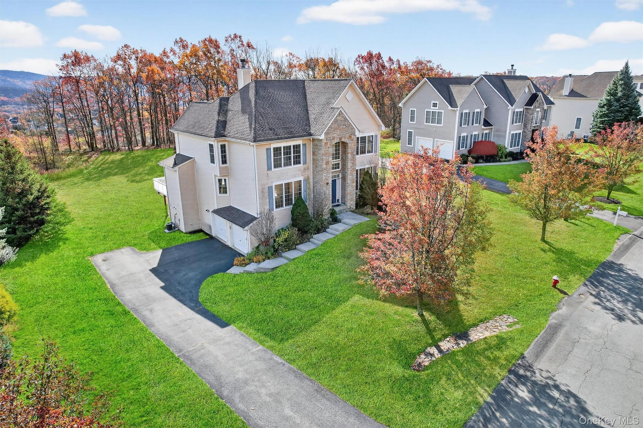 12 Heather Ridge Highland Mills, NY 10930 - Photo 5 of 41 a aerial view of a house with a yard table and chairs
