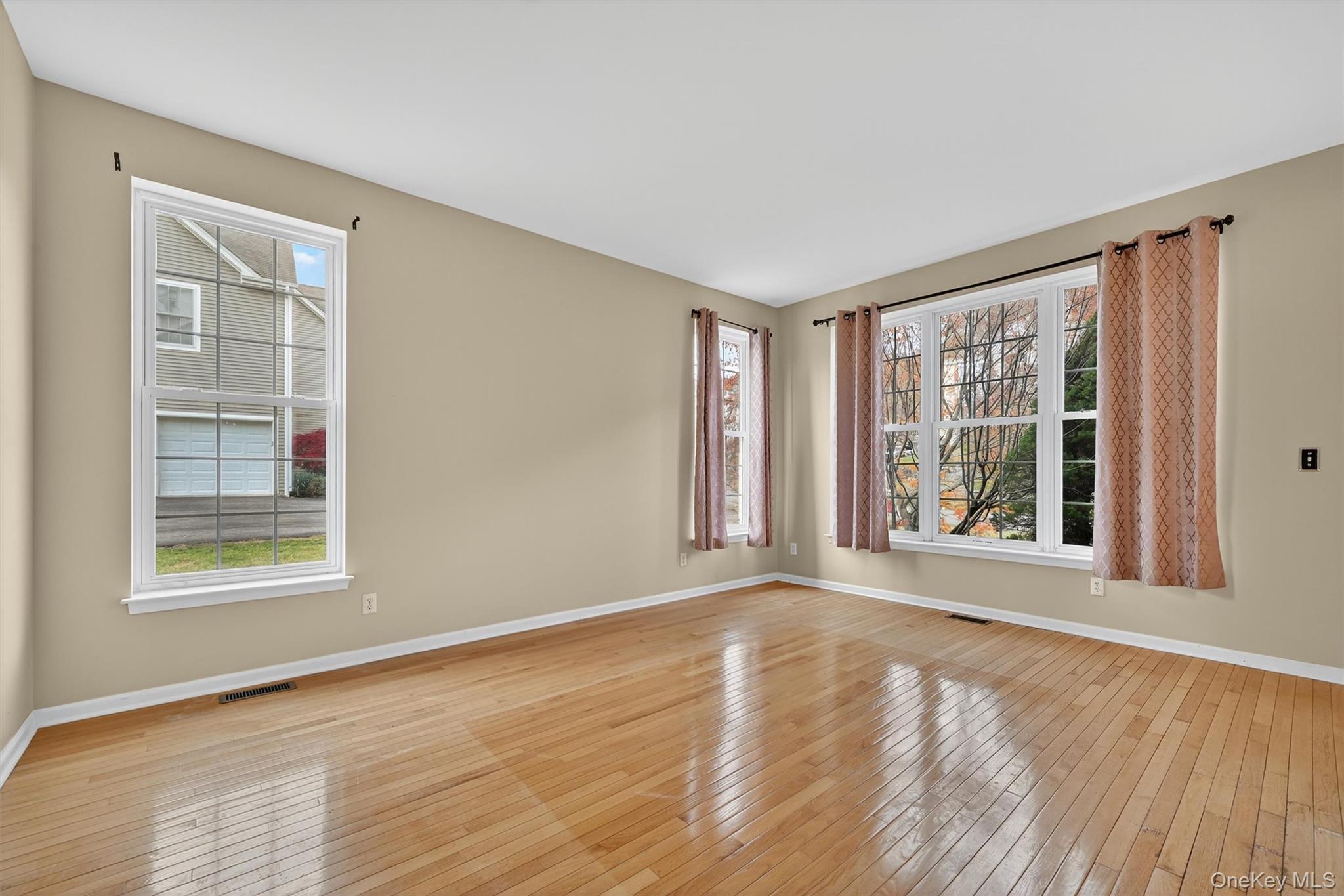 12 Heather Ridge Highland Mills, NY 10930 - Photo 7 of 41 a view of an empty room with wooden floor and a window