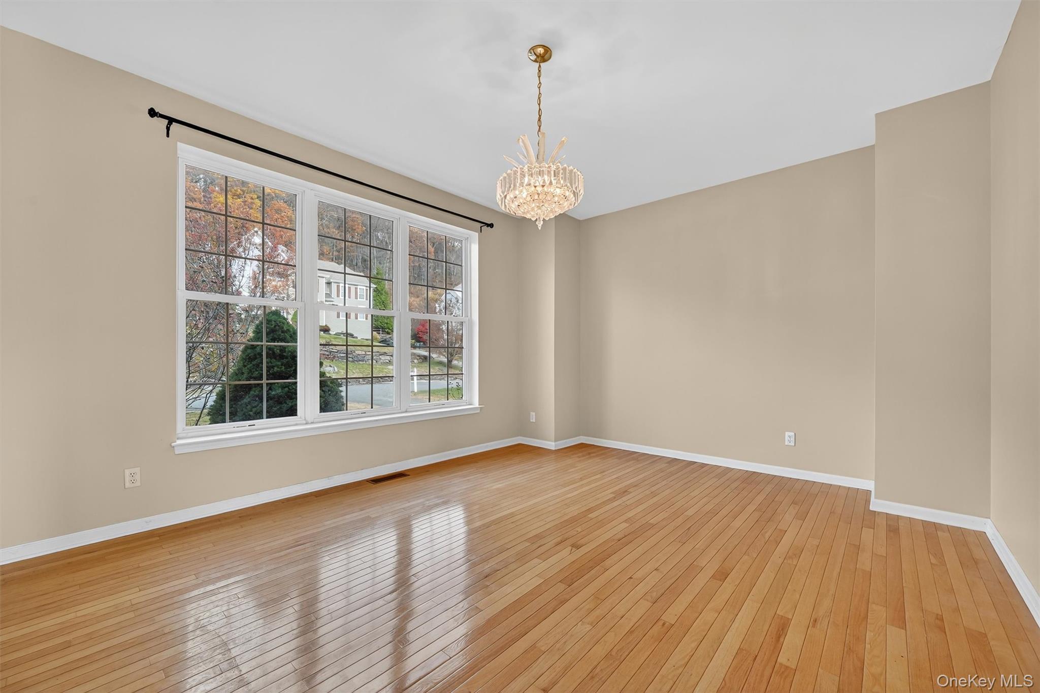 12 Heather Ridge Highland Mills, NY 10930 - Photo 9 of 41 a view of an empty room with wooden floor and a window