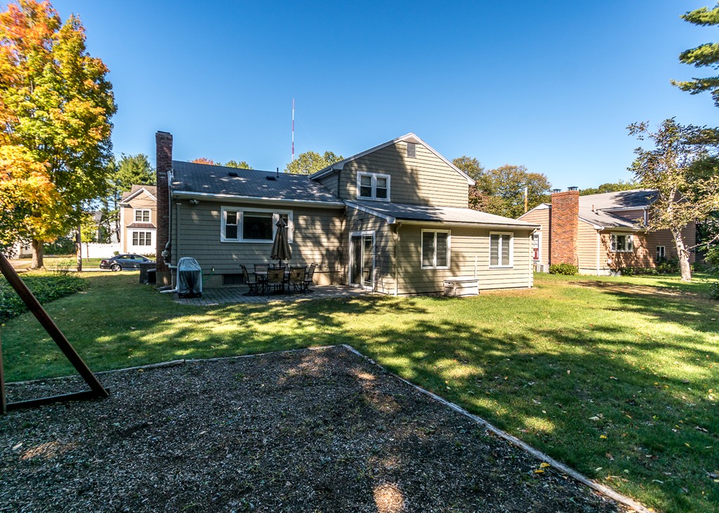 87 Evelyn Road Needham, MA 02494 - Photo 13 of 14 a front view of a house with a yard table and chairs