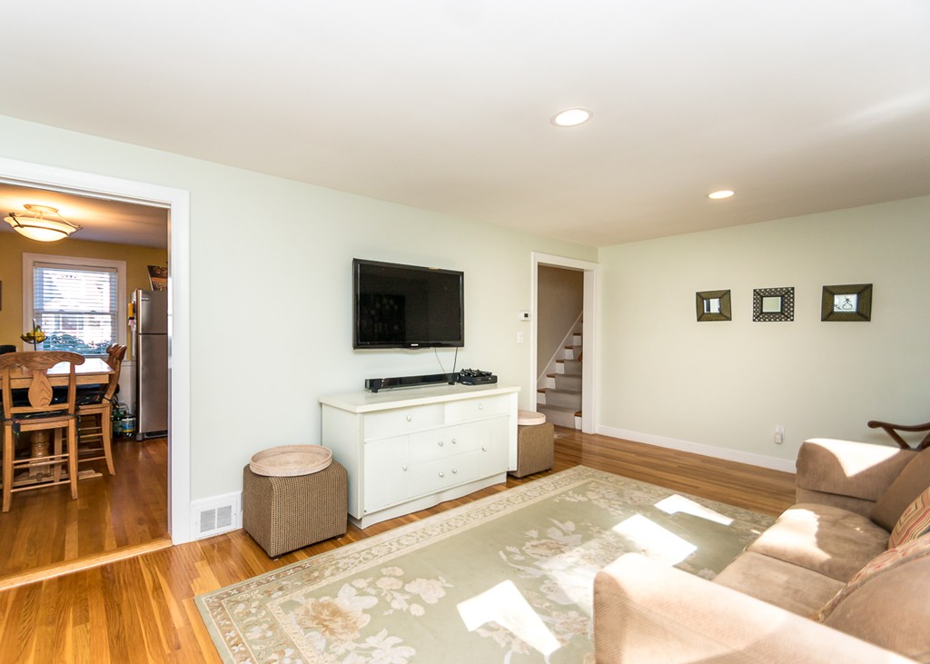 87 Evelyn Road Needham, MA 02494 - Photo 3 of 14 a spacious bedroom with a bed and a flat screen tv
