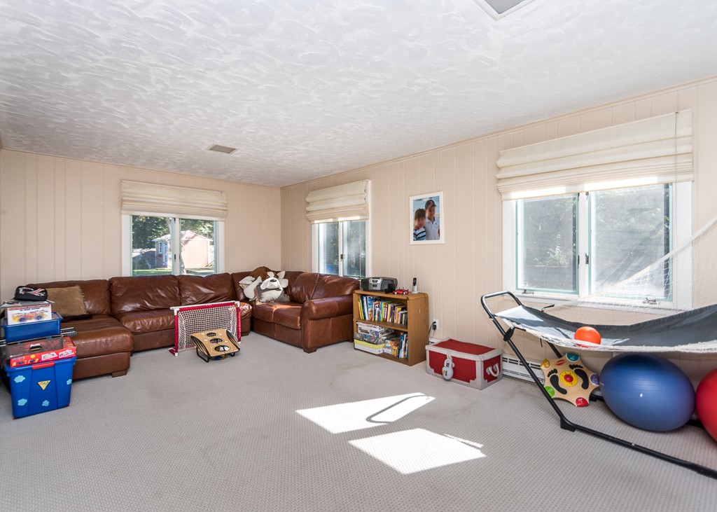 87 Evelyn Road Needham, MA 02494 - Photo 7 of 14 a living room with furniture and windows