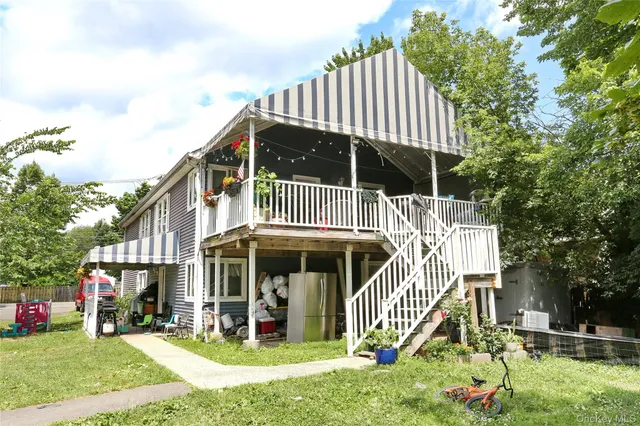 a front view of a house with a yard table and chairs