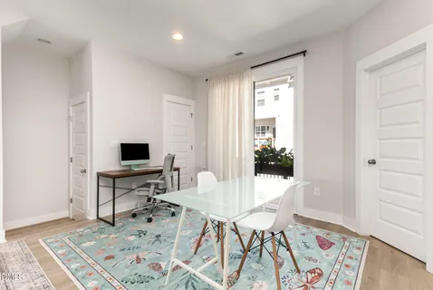 a spacious bedroom with a bed and a flat screen tv