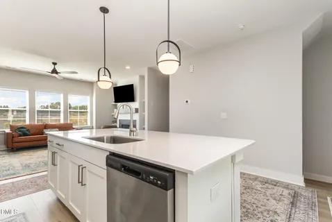 a kitchen with stainless steel appliances kitchen island granite countertop a stove a sink and a refrigerator