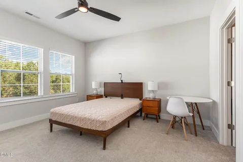 a kitchen with stainless steel appliances granite countertop a refrigerator a stove a dining table and chairs with wooden floor