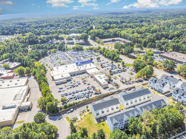 an aerial view of residential building with green space