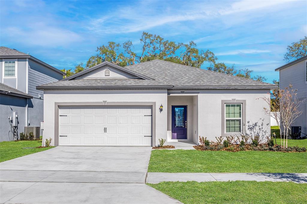 a front view of a house with a garden and plants
