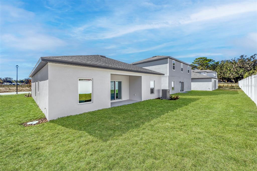 13283 Tula Loop Astatula, FL 34705 - Photo 18 of 19 a front view of house with yard and green space