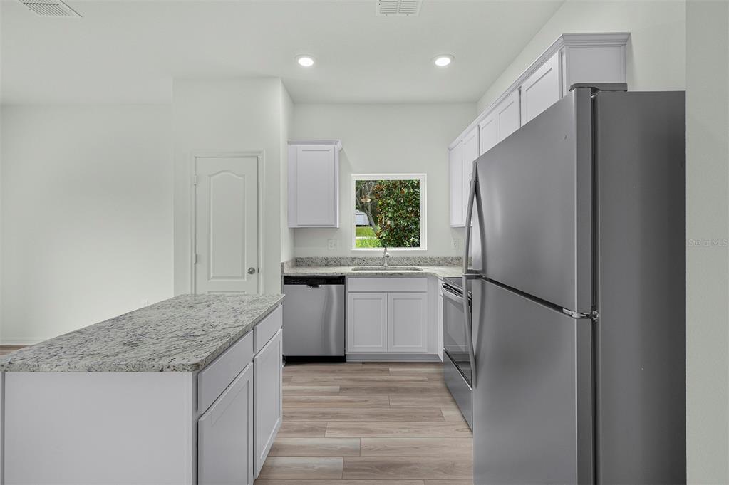 13283 Tula Loop Astatula, FL 34705 - Photo 5 of 19 a kitchen with a refrigerator and a sink