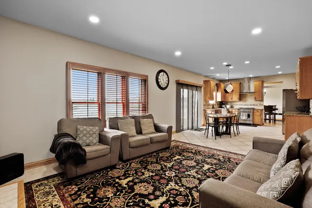 a bedroom with a bed and a dresser with wooden floor