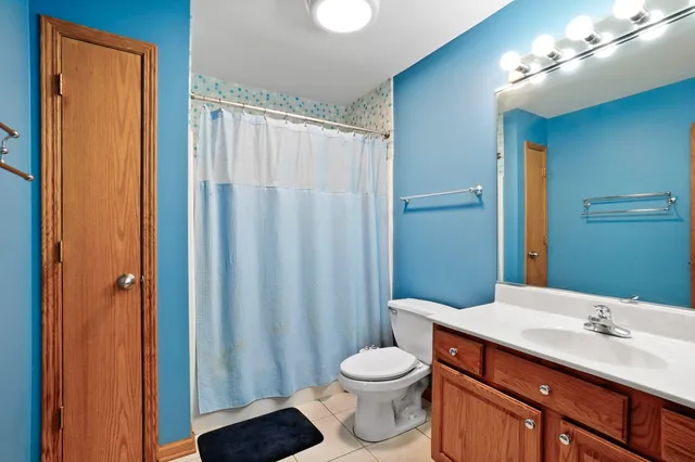 a spacious bathroom with a mirror sink and shower