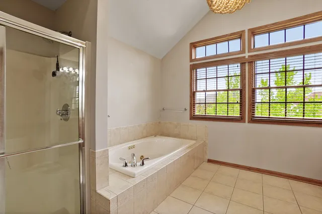 a bedroom with a large bed and a flat screen tv